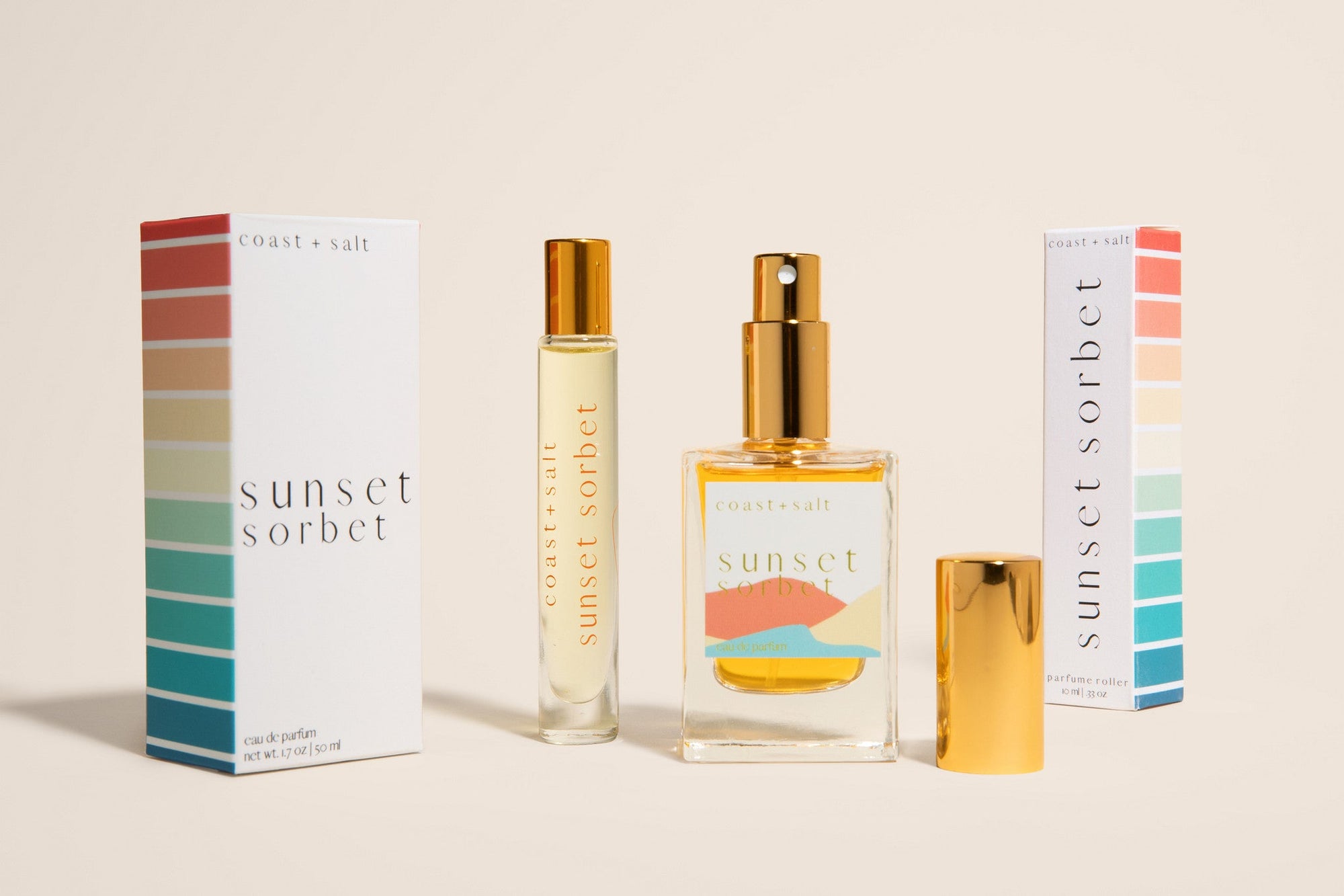 Sunset Sorbet eau de parfum and perfume roller with retail packaging on a neutral background
