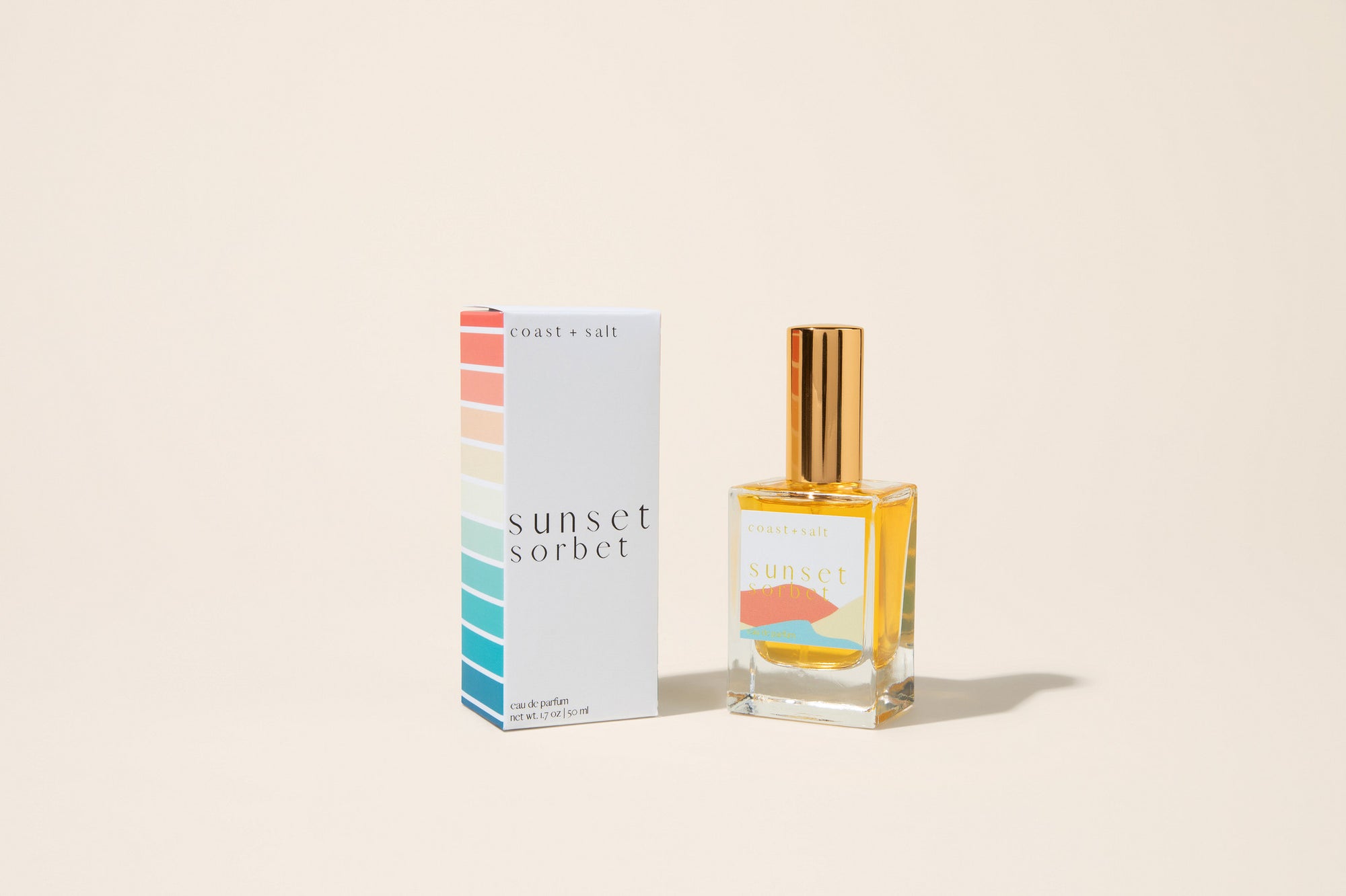 Perfume bottle and packaging labeled 'Sunset Sorbet' on a beige background