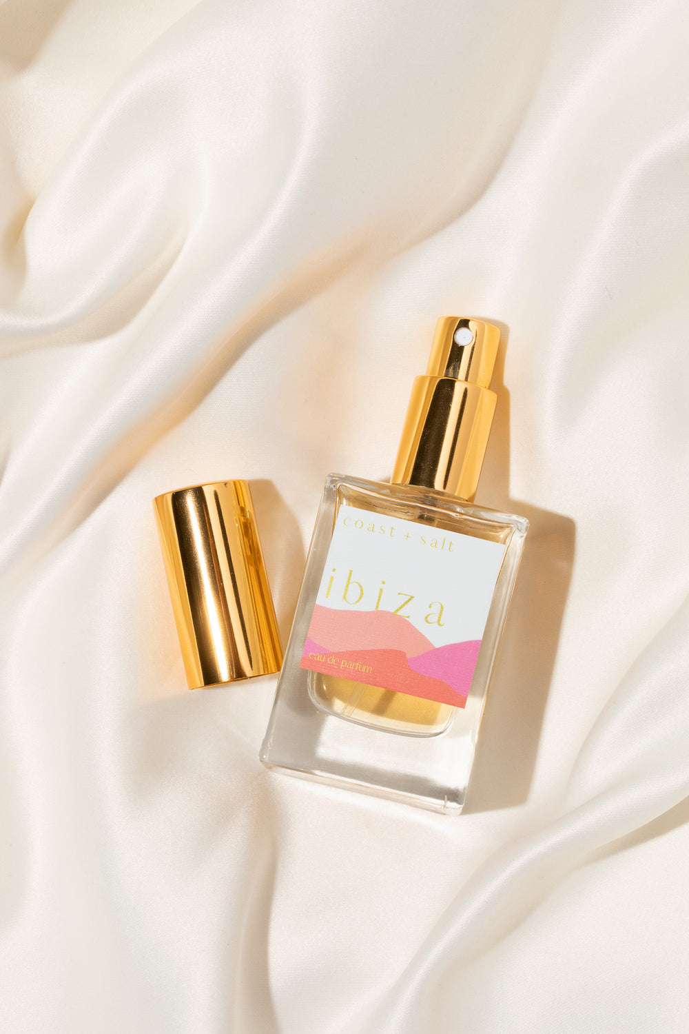 Bottle of Ibiza Eau de Parfum on white silk sheet