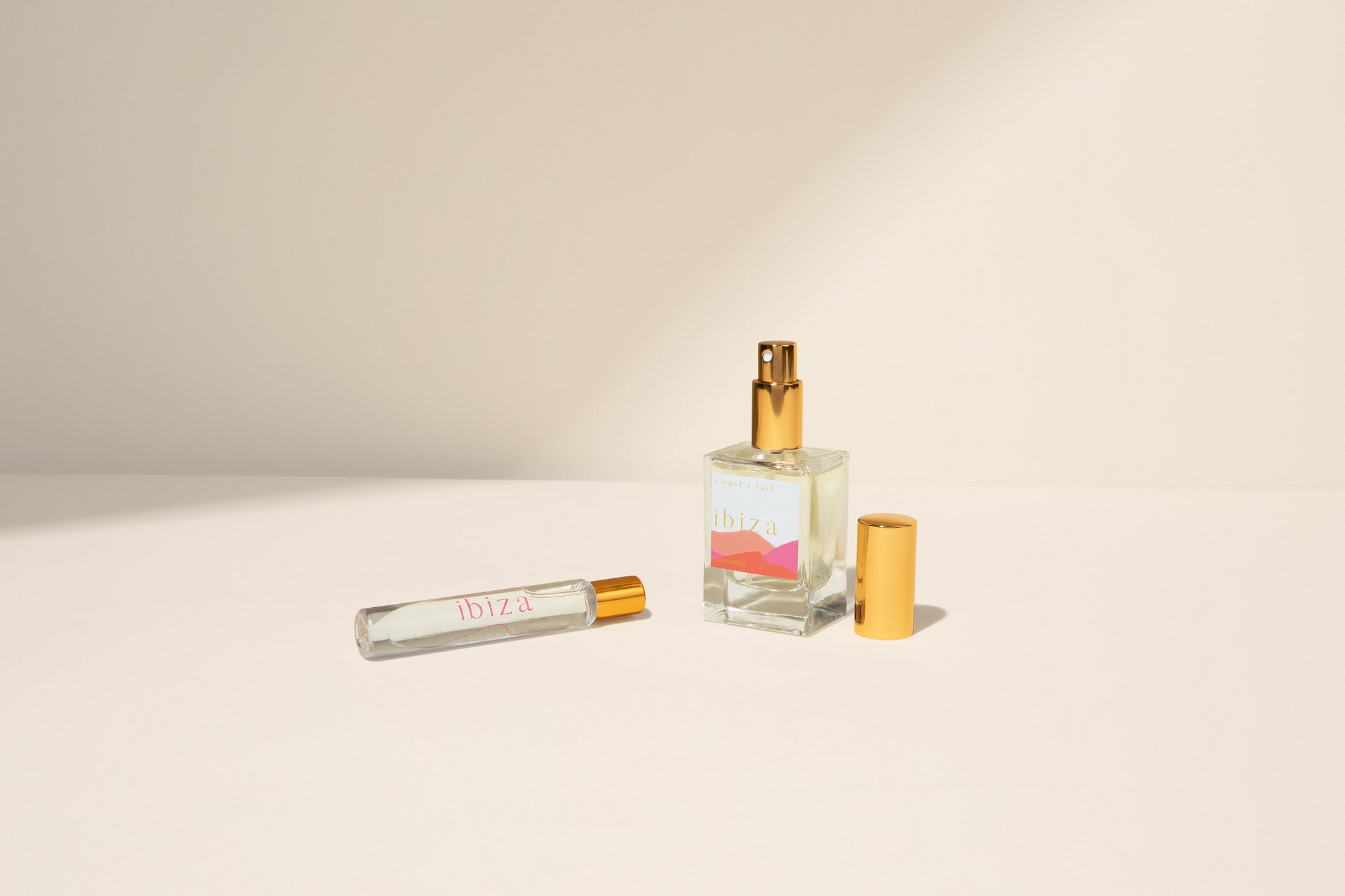Ibiza Perfume bottle with a small Rollerball on a beige background